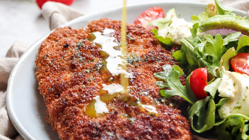 Milanesa de pollo empanizada con huevo, pan rallado y queso parmesano